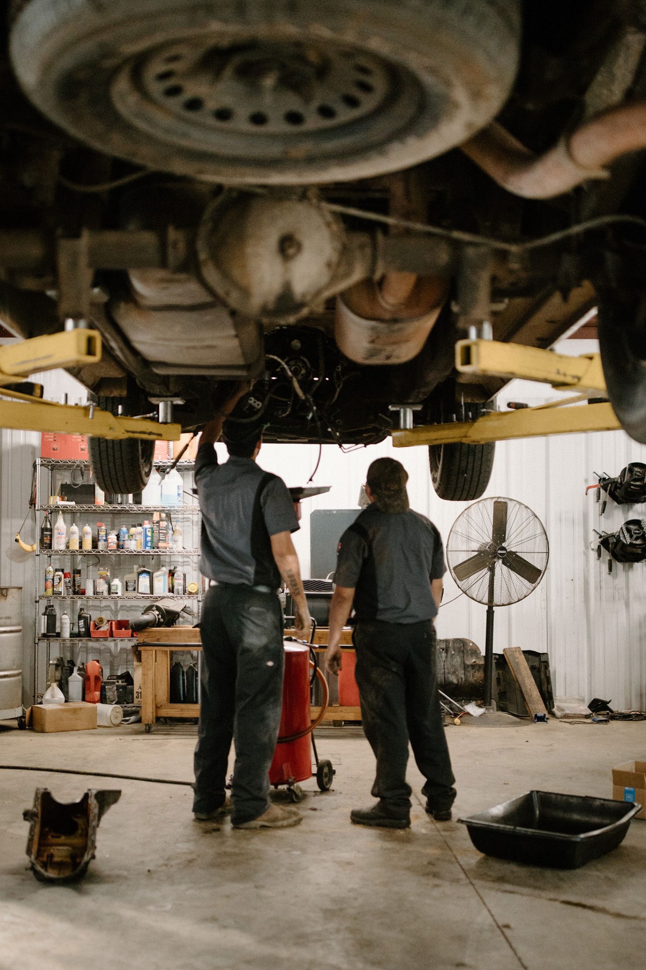 Mechanics working under vehicle lift